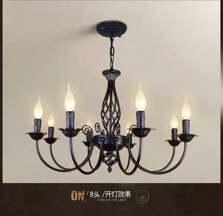 Black iron chandelier with ornate scrollwork and six candle-style bulbs for modern black iron living room decor