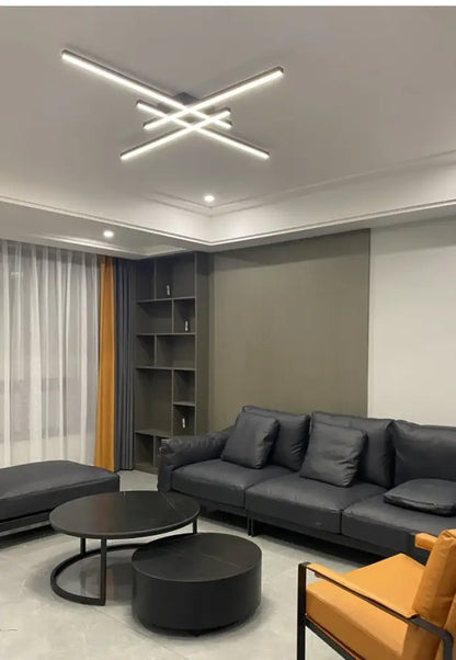 Modern black leather sofa with matching cushions beneath a sleek black chandelier square for bedroom and living room