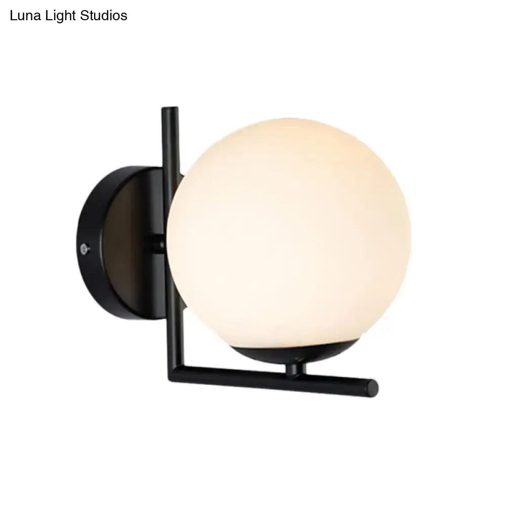 Modern black metal wall sconce with frosted black opal glass globe for bedroom lighting fixture