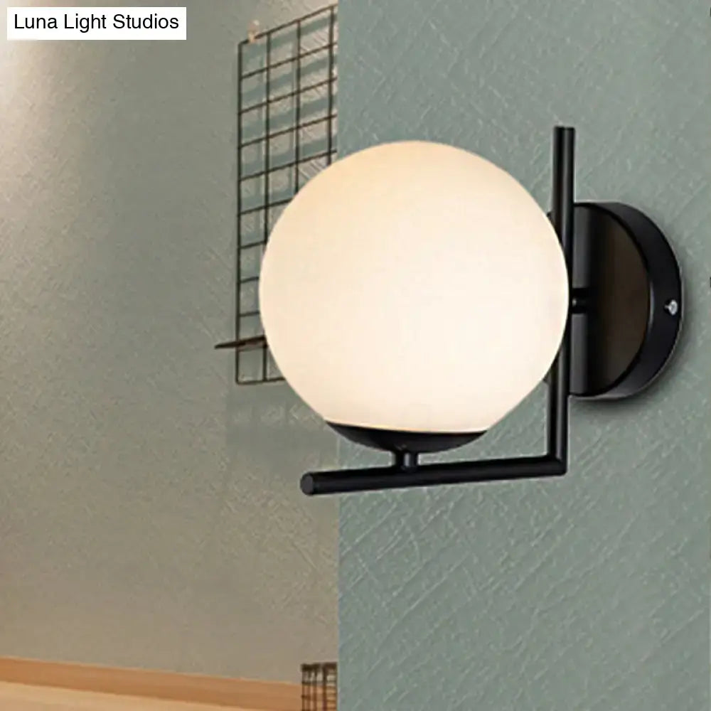 Modern black metal wall sconce with frosted white black opal glass globe for bedroom lighting fixture