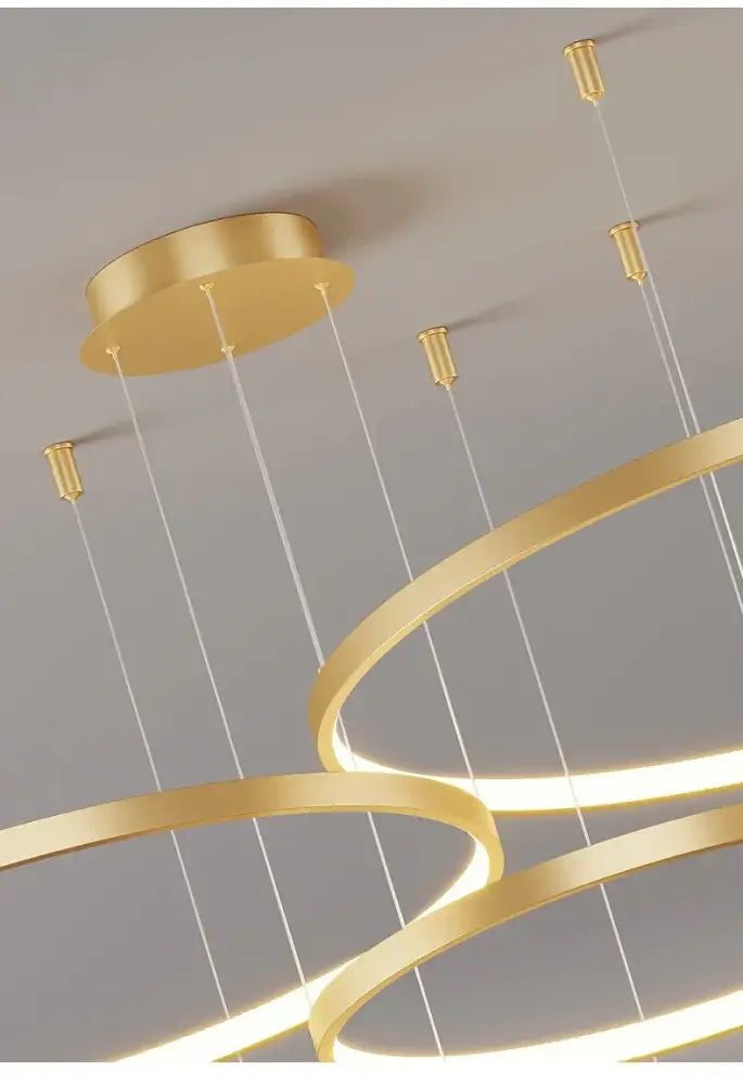 Gold-colored modern chandelier with sleek interlocking rings and thin cables for living room pendant light decorbites modern black pendant
