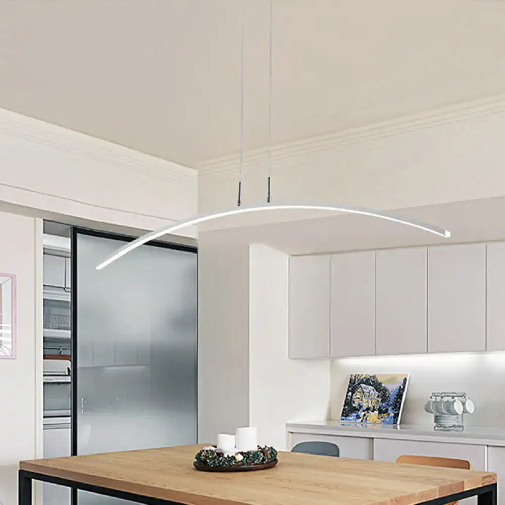 Modern white curved DecorBites pendant light with black white arch acrylic LED and warm white glow above wooden table