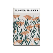 A floral-patterned notebook with orange daisies and green stems titled flower market paired with a decorbites™ modern black and white bauhaus canvas print