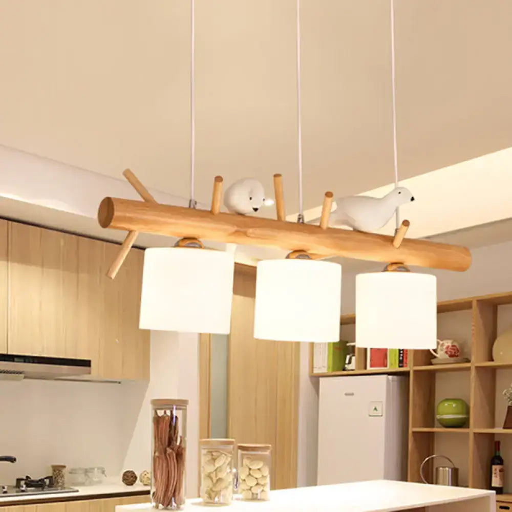 DecorBites modern wooden branch island pendant light with three cream glass shades and two white bird figurines for dining room