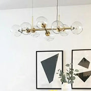 DecorBites modern brass island light with dome glass shades featuring clear globe bulbs for dining room suspension lighting