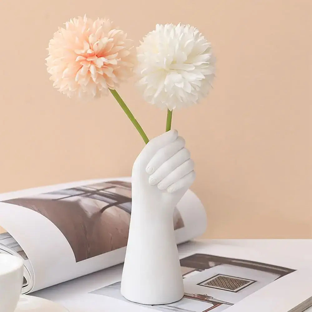 White ceramic arm vase shaped like a hand holding two fluffy flowers decorbites modern flower vase