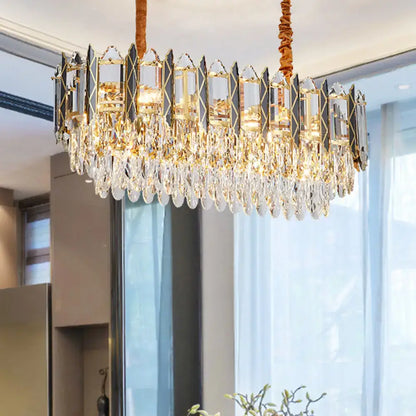Elegant gold-toned decorbites™ crystal tiered oblong island light fixture with faceted crystal droplets and glass panels
