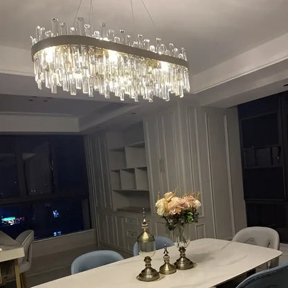 DecorBites modern oval crystal chandelier with cascading clear prisms and golden chrome frame for dining room lighting