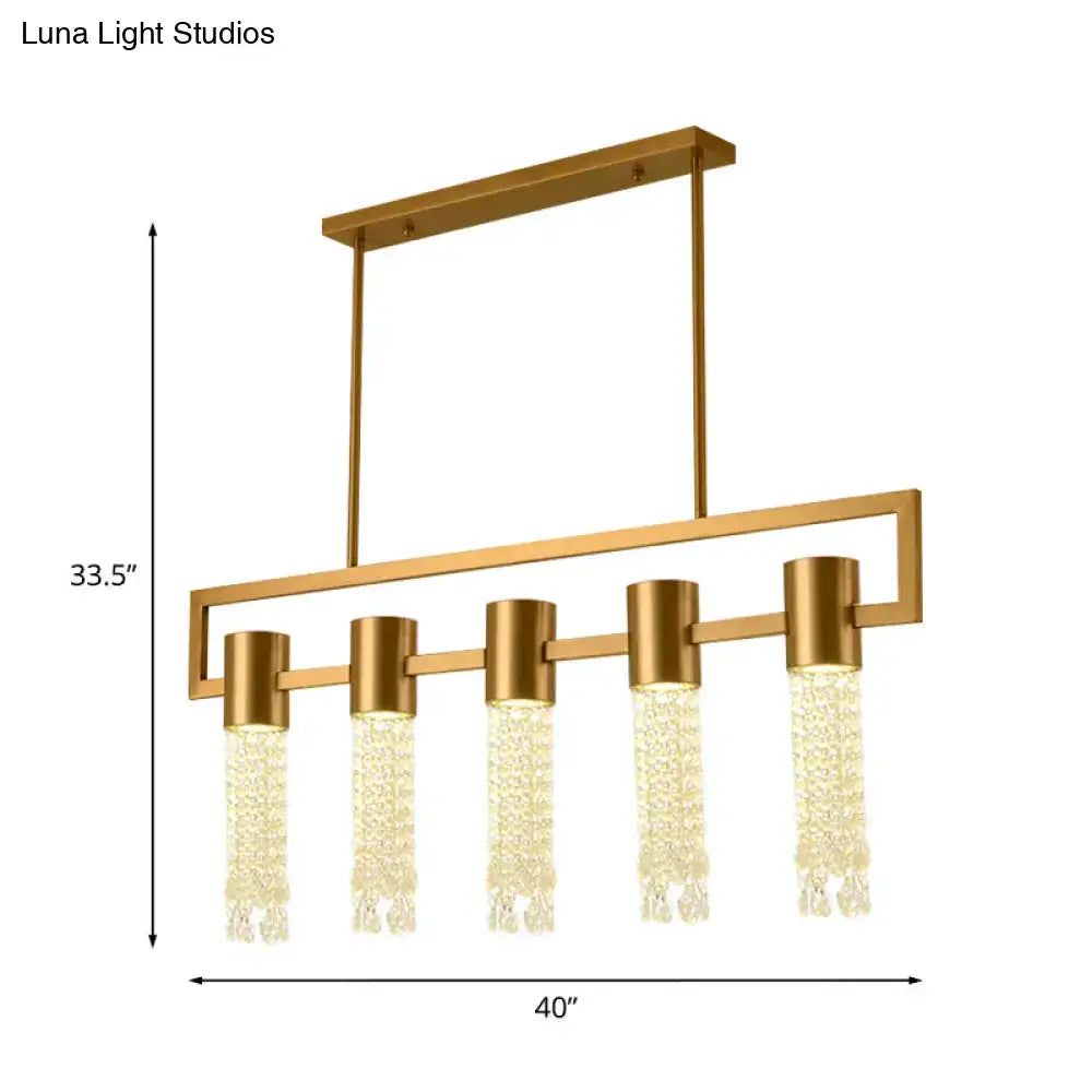 Gold-toned modern crystal draping lighting fixture with five cascading pendant lights for island pendant use