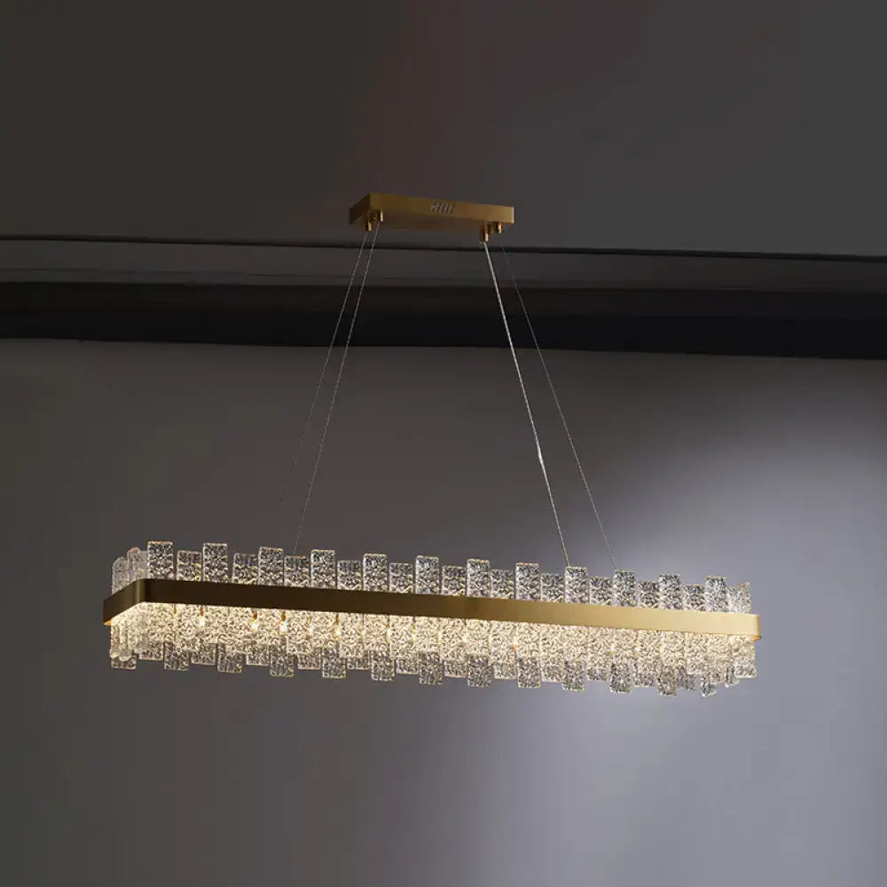 DecorBites™ modern crystal loop pendant light with brass plated frame and clear crystal cubes in a rectangular design