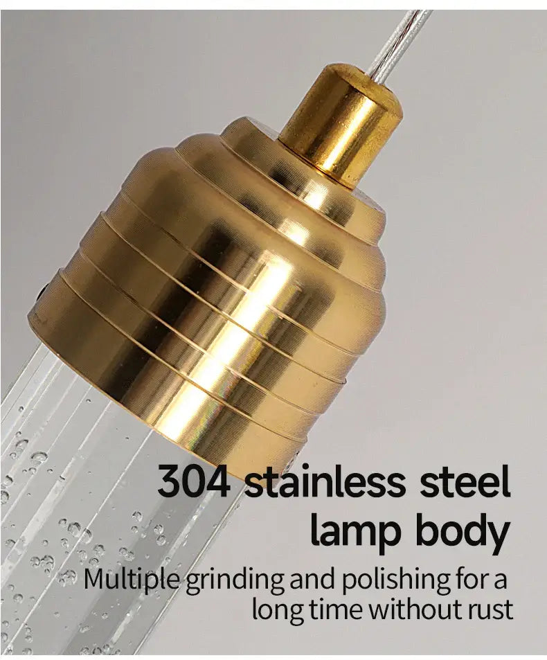 DecorBites™ modern crystal pendant light with gold-toned 304 stainless steel ribbed body and clear glass tubing