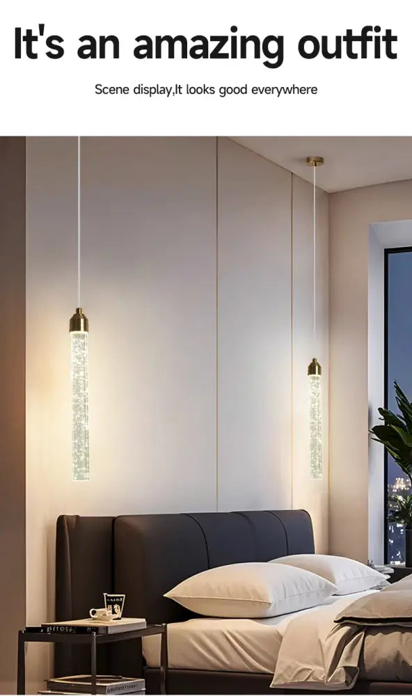 Two elegant decorbites™ modern crystal pendant lights with gold fixtures and translucent cylindrical glass bodies