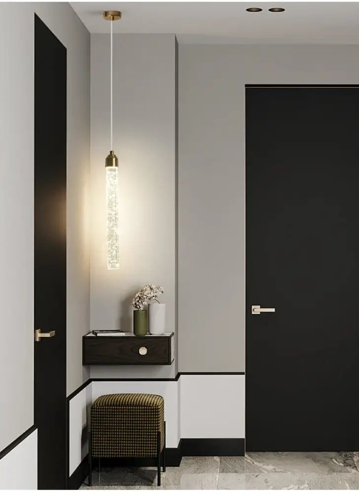 DecorBites™ modern crystal pendant light with brass-finished gold fixtures and sparkling illuminated glass tube