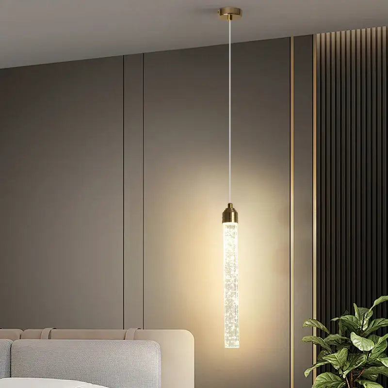 DecorBites™ modern crystal pendant light with gold fixtures features a sleek cylindrical design and sparkling clear glass