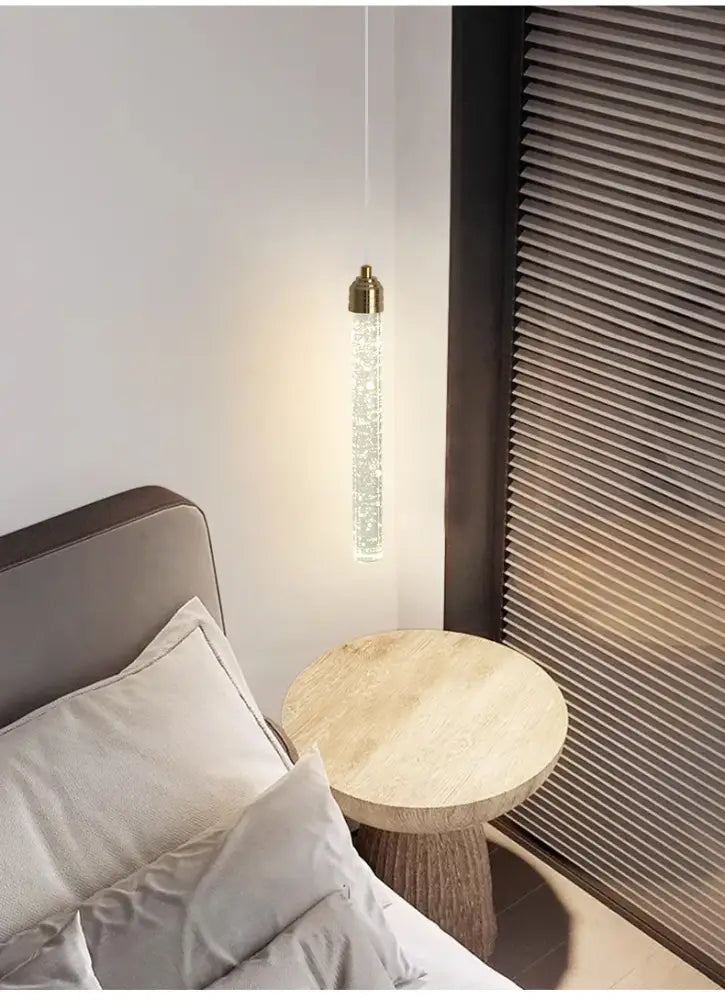 DecorBites modern crystal pendant light with gold fixtures features a sleek cylindrical design and clear crystal beads