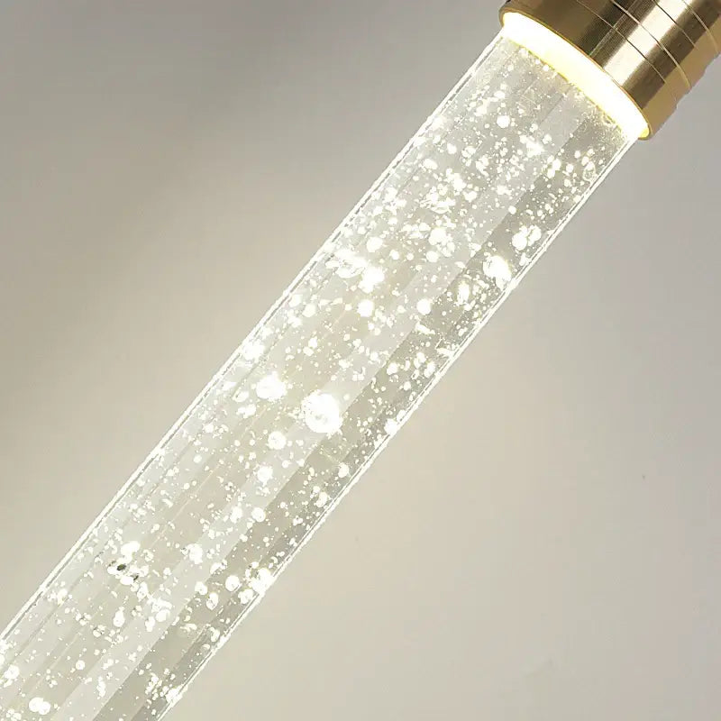 DecorBites modern crystal pendant light with clear glass tube, gold fixtures, and internal floating bubbles pendant light