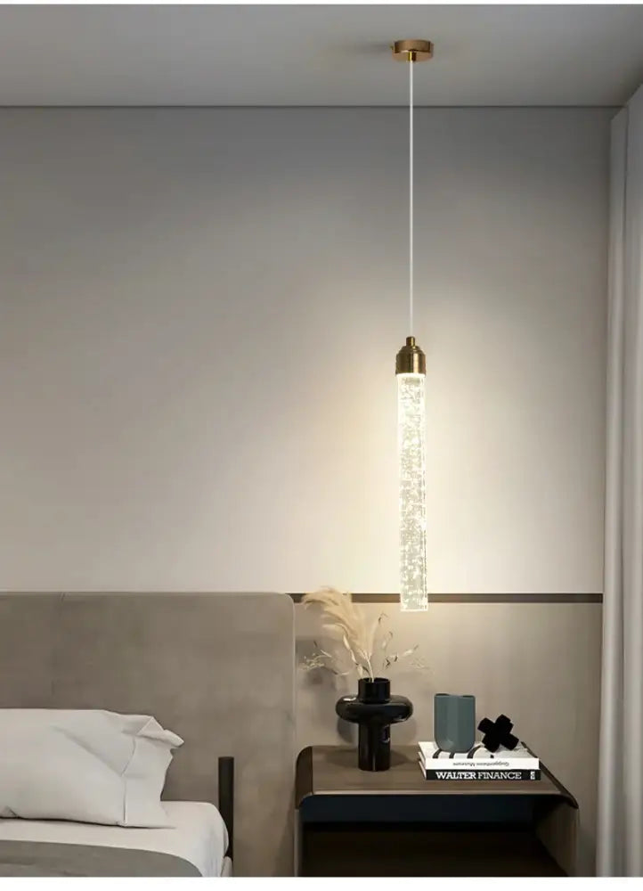 DecorBites™ modern crystal pendant light with gold fixtures features a cylindrical glass body filled with sparkling crystals