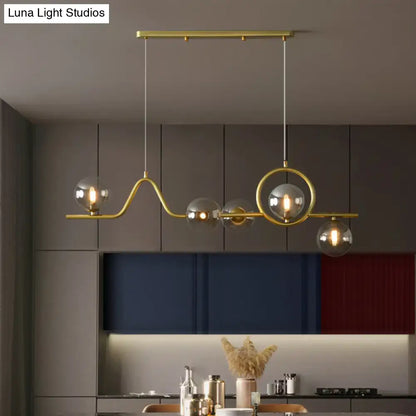 Decorbites modern curve island ceiling light with gold-toned metal arms and clear glass globe bulbs for dining room