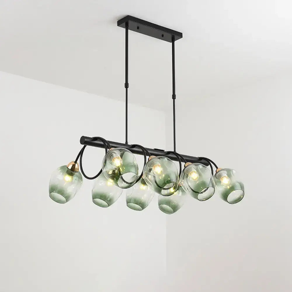 DecorBites modern black metal wine cup island light with six translucent green glass dimpled globe shades