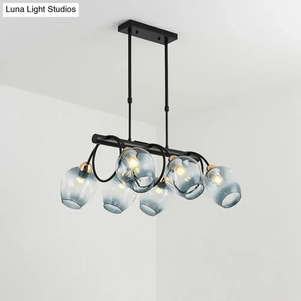 Modern black metal island light with five frosted blue glass globes and brass accents for cup island lighting