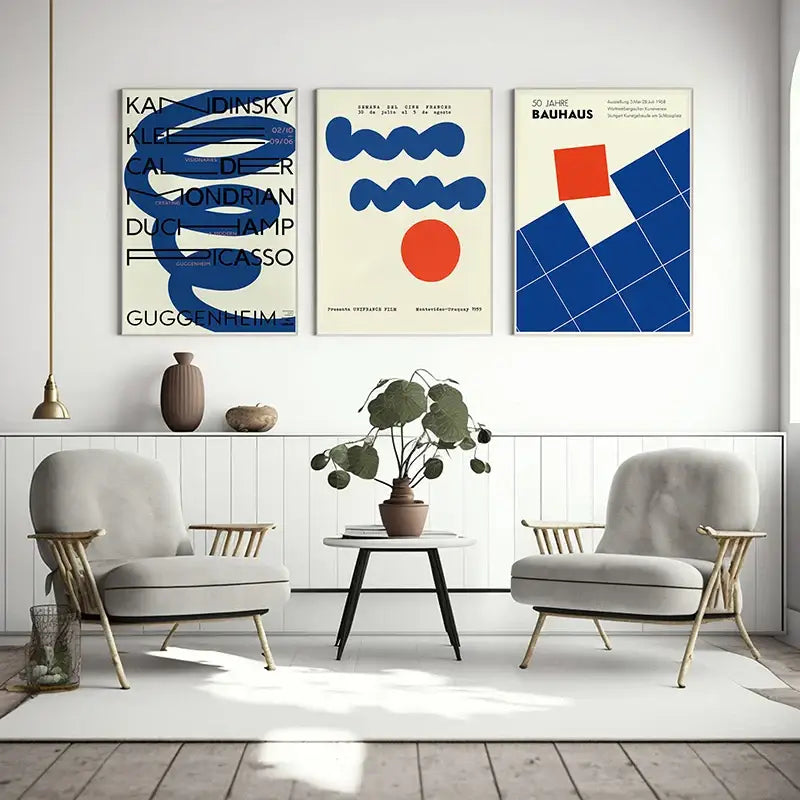 Three framed DecorBites™ modern geometric bauhaus canvas wall art posters with bold blue orange and black designs on cream backgrounds