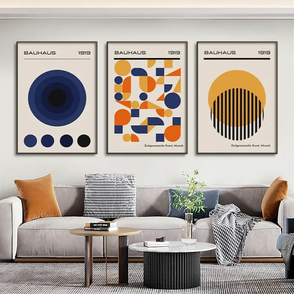 Three framed DecorBites™ modern geometric canvas wall art prints with blue orange and black designs on cream backgrounds