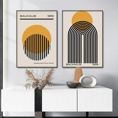 Two minimalist bauhaus 1919 framed posters featuring bold black and ochre geometric designs on cream modern geometric canvas wall art