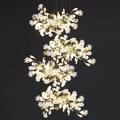 Elegant white and gold DecorBites™ modern ginkgo leaf LED chandelier with cascading petal shades for dining room lighting