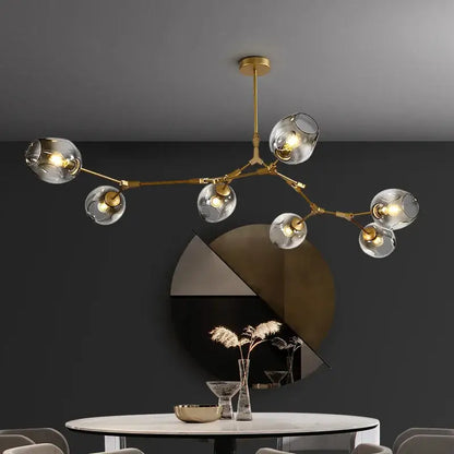 Gold-toned DecorBites™ modern glass ball pendant chandelier with clear globe shades in black gold finish