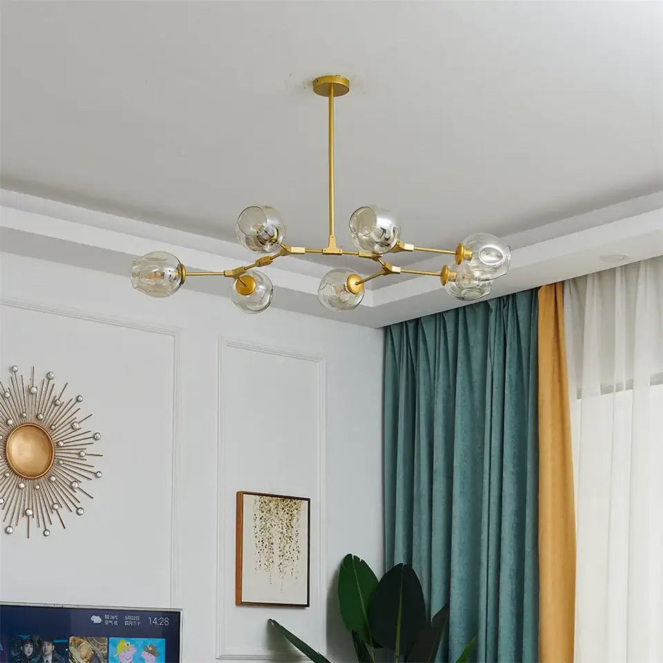 DecorBites™ modern glass ball pendant chandelier in black gold with six clear glass globe bulbs and nordic glass ball design