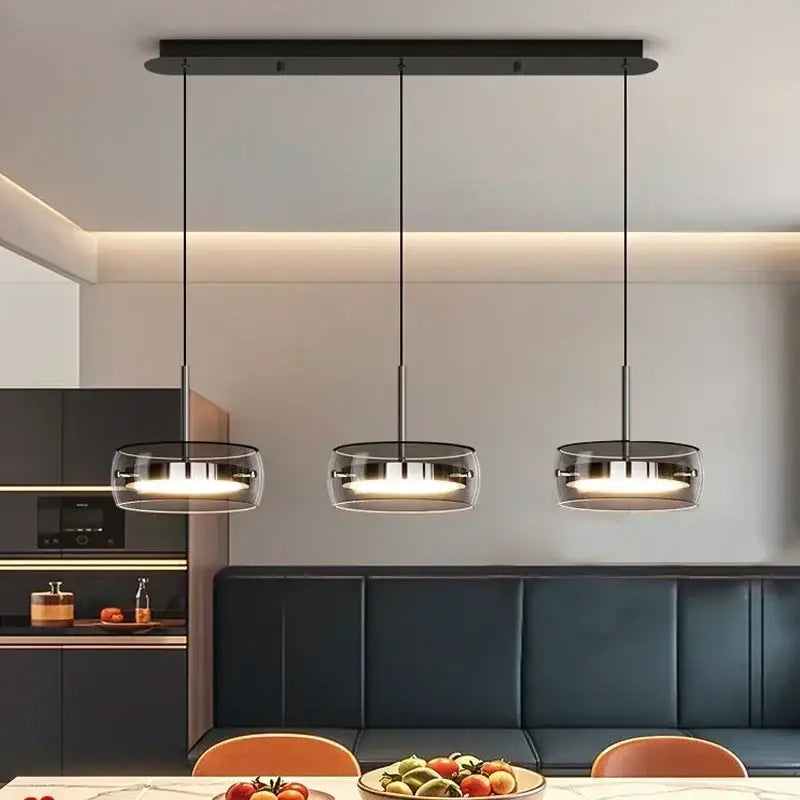 Modern black pendant light with clear glass shades and sleek metal fixtures for dining table pendant use by DecorBites™