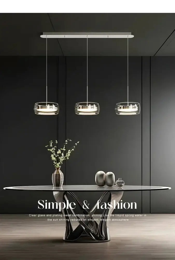 DecorBites Modern glass dining table pendant light with clear glass shades and sleek metallic frames above table