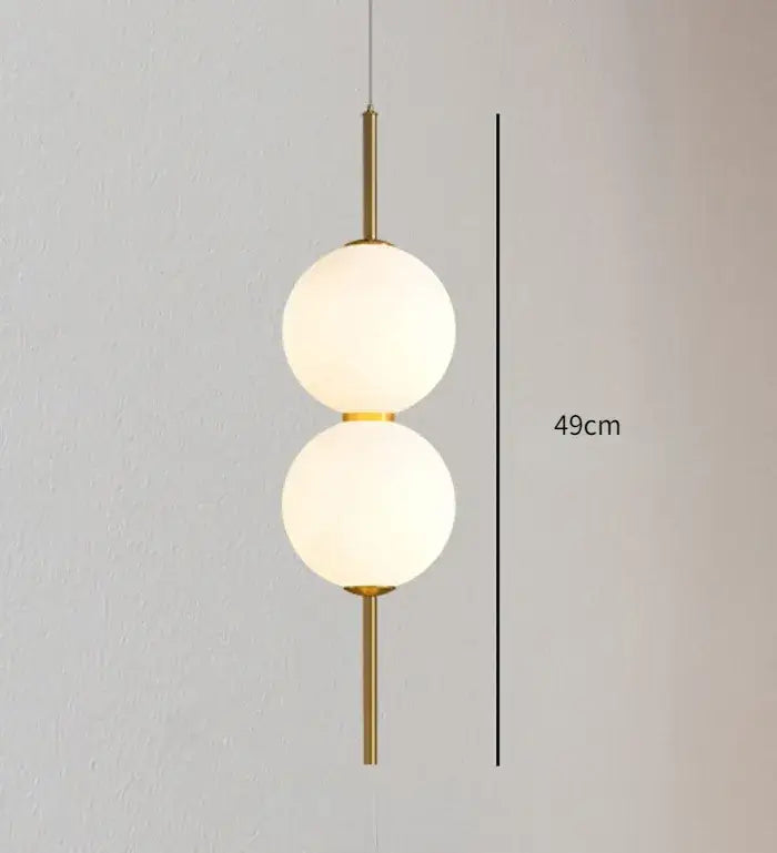 DecorBites™ modern glass pendant lighting with gold-toned fixture and two vertically stacked frosted glass spheres