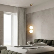 DecorBites™ modern glass pendant lighting with two spherical glass bulbs suspended by a gold-toned chain