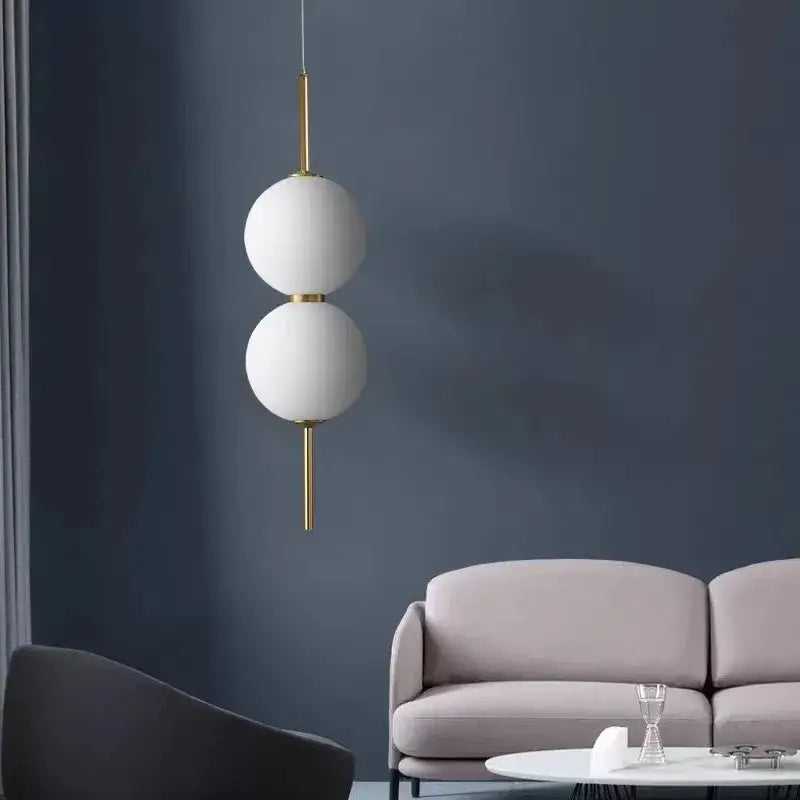 DecorBites™ modern glass pendant lighting with two stacked white spherical glass shades and gold-toned metal rod suspension