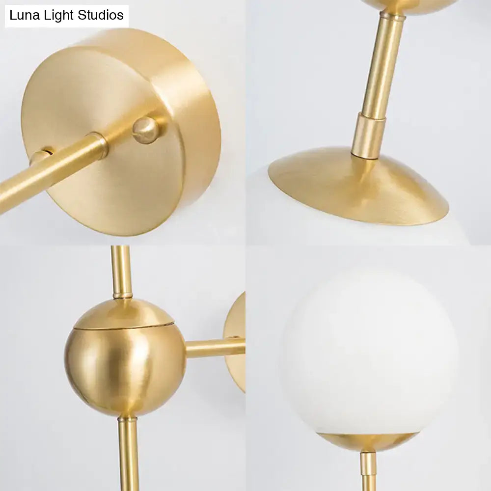 Modern brass and white glass globe sconce with frosted white glass shade direct wired led light for bathroom use