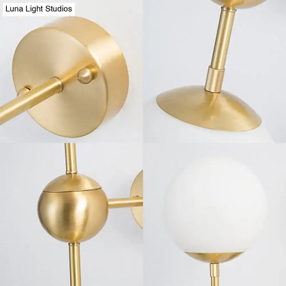Modern brass and white glass globe sconce with frosted white glass shade direct wired led light for bathroom use