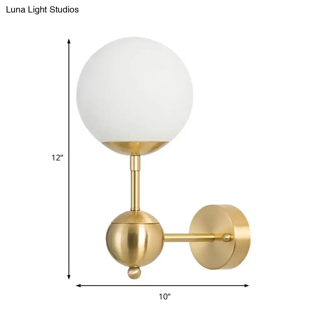 Modern brass wall sconce with white glass frosted globe direct wired led light for bathroom use