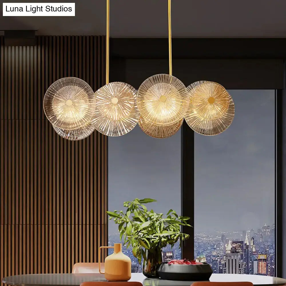 Modern gold finish DecorBites pendant light with prismatic glass shade featuring four etched circular LED bulbs