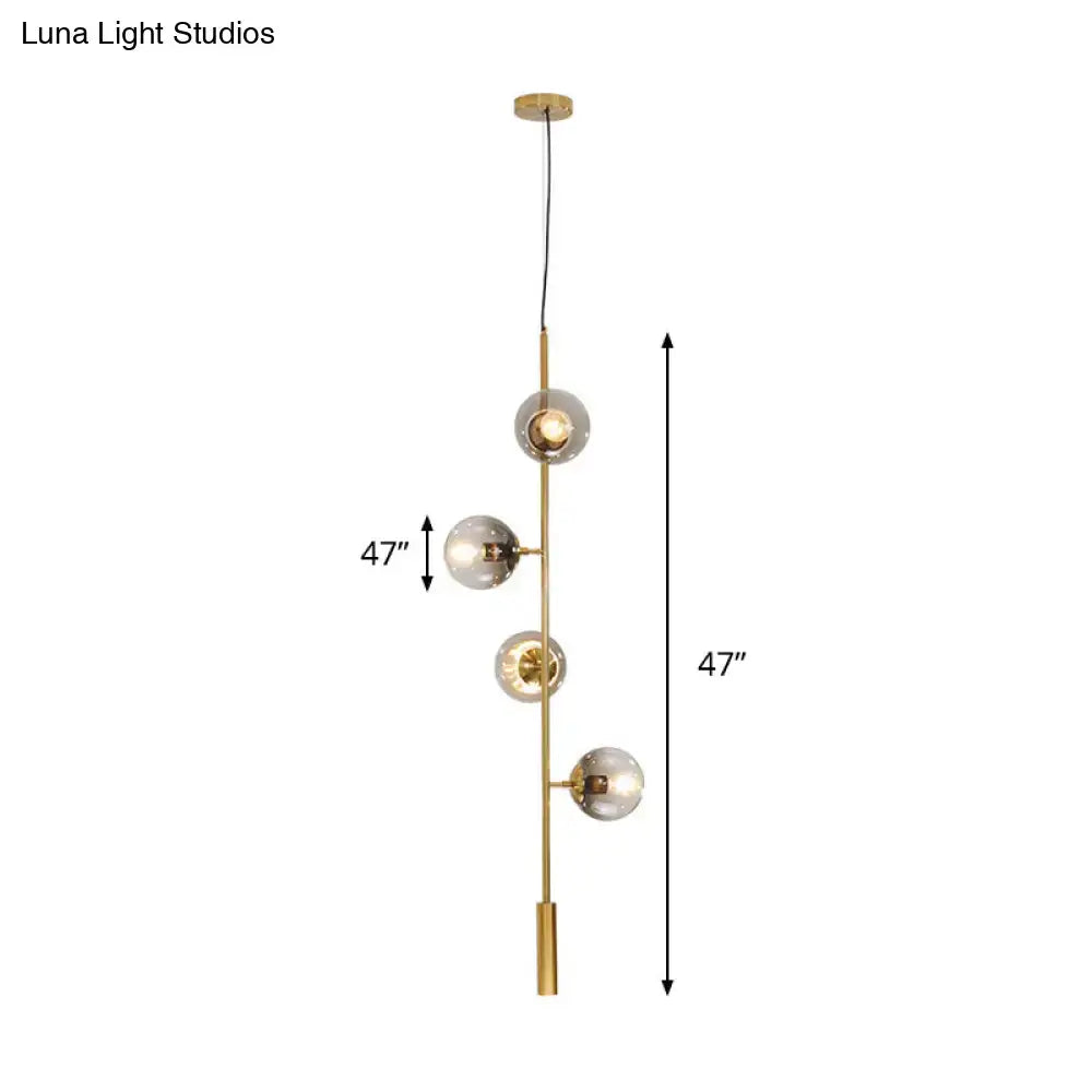 DecorBites modern gold linear chandelier with four gray glass shades on a slender metal rod hanging fixture