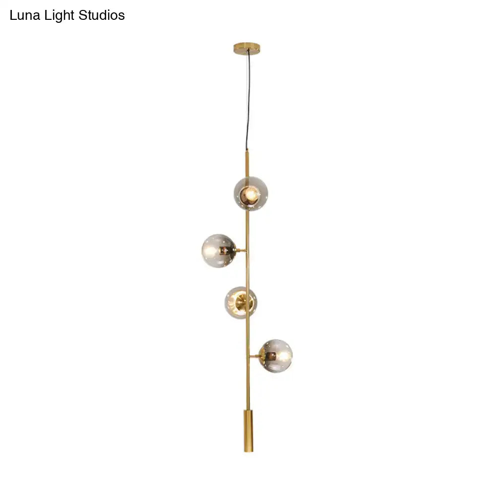 DecorBites™ modern gold pendant light with five gray glass shades on a slender metal rod for stylish indoor lighting