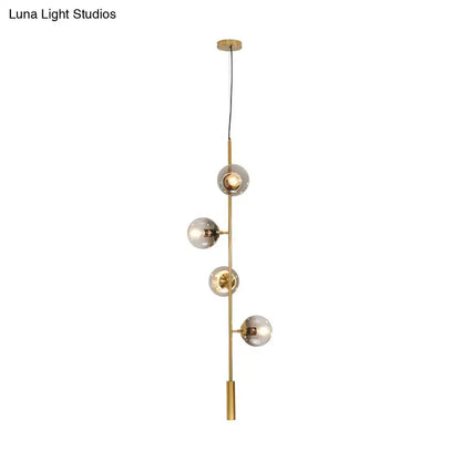 DecorBites™ modern gold pendant light with five gray glass shades on a slender metal rod for stylish indoor lighting