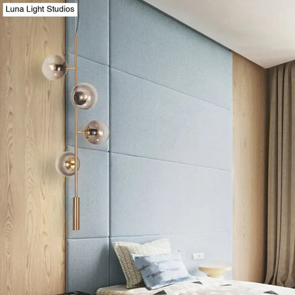 Decorbites modern gold linear chandelier with brass finish and four smoke gray glass shades wall sconce