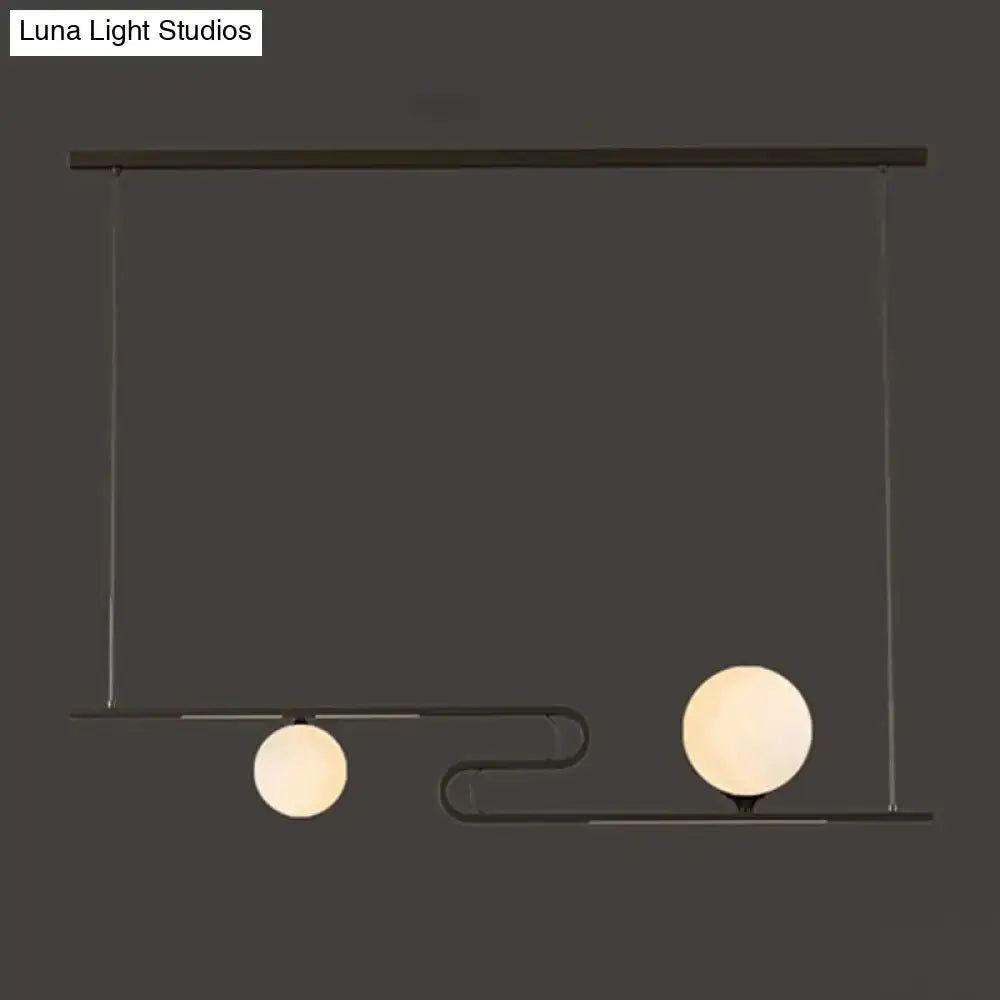 Modern black metal hanging chandelier with two frosted glass globes from DecorBites simplicity modo collection for dining hall