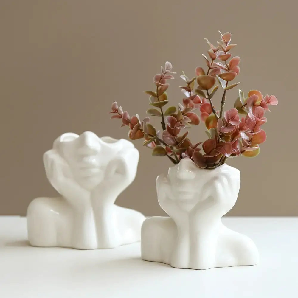 White ceramic resin vase by decorbites shaped like a human body bust with hands cupping the face for body shaping decor