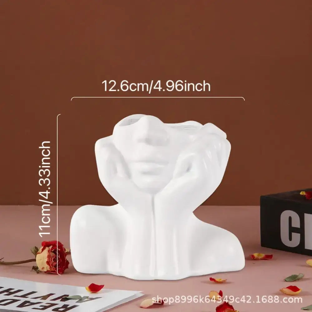 White ceramic resin vase by DecorBites shaped like a human body bust with hands framing the face for modern decor