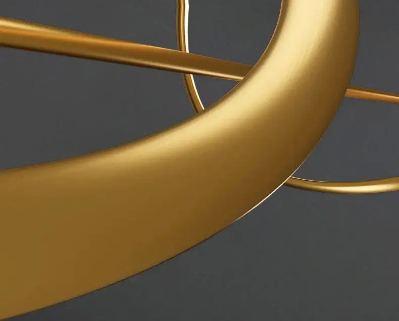 Golden metallic DecorBites™ modern LED chandelier with sleek curved arms and geometric design for dining or bedroom use