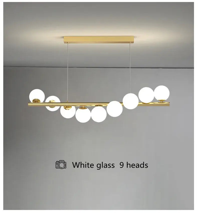 Gold-toned decorbites modern led glass chandelier with nine white glass bulbs on a horizontal bar for dining room use