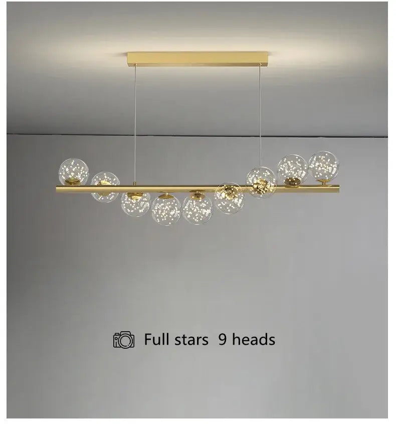 Gold-toned DecorBites™ modern led glass chandelier with nine clear glass globes on horizontal bar for dining room lighting
