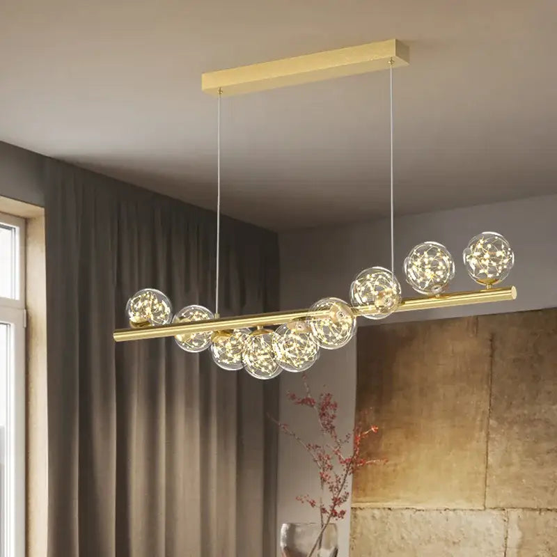 Gold-toned DecorBites™ modern led glass chandelier with clear glass spheres and warm led lights for dining room